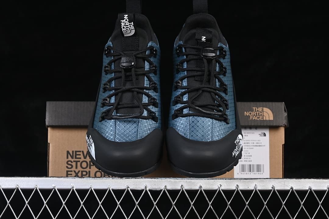 Front view of the pair displayed in front of the shoe box.
