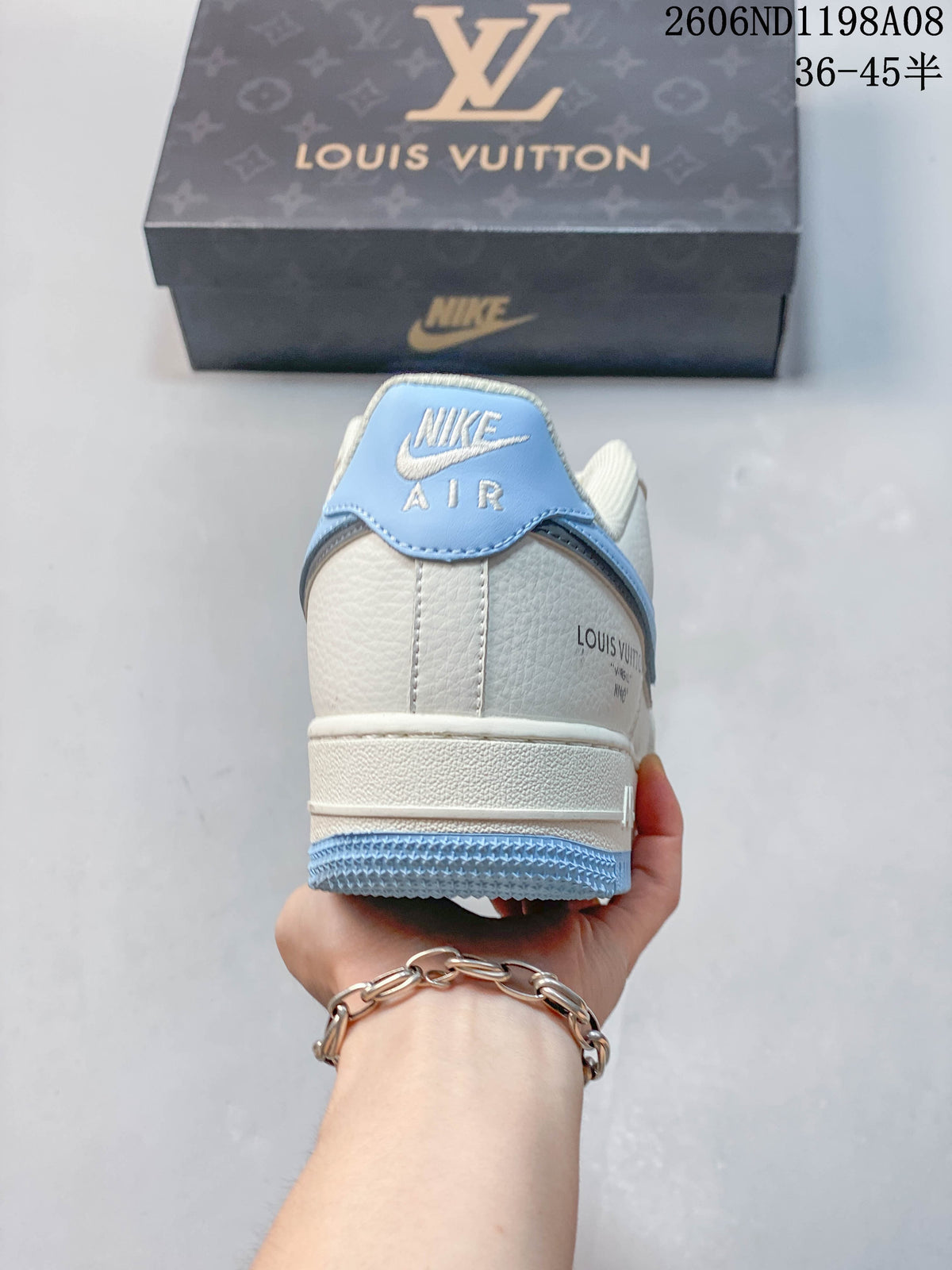 Rear view of the sneaker showing a light blue heel tab and branded details
