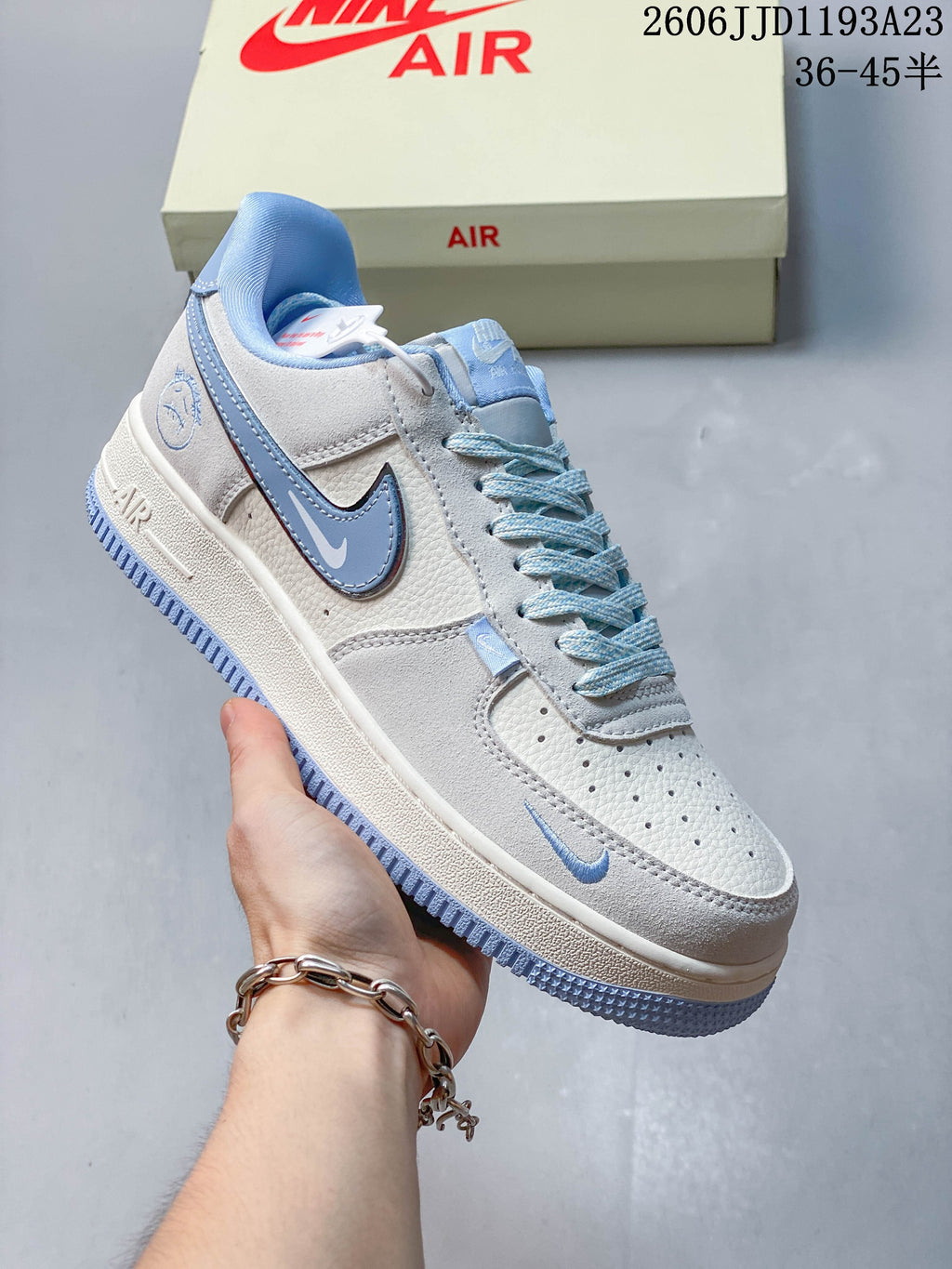 Close view of a white and ice-blue sneaker with blue side Swoosh and heel graphic