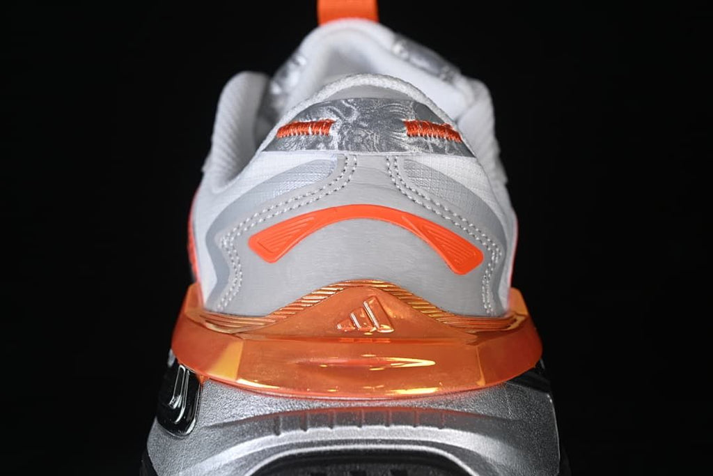 Rear view highlighting the orange heel detail and sculpted sole