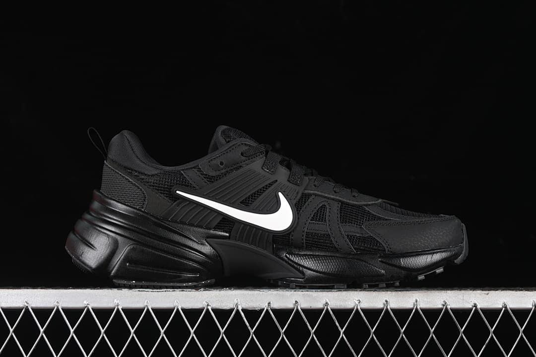 Side profile of the black sneaker with a white Swoosh.
