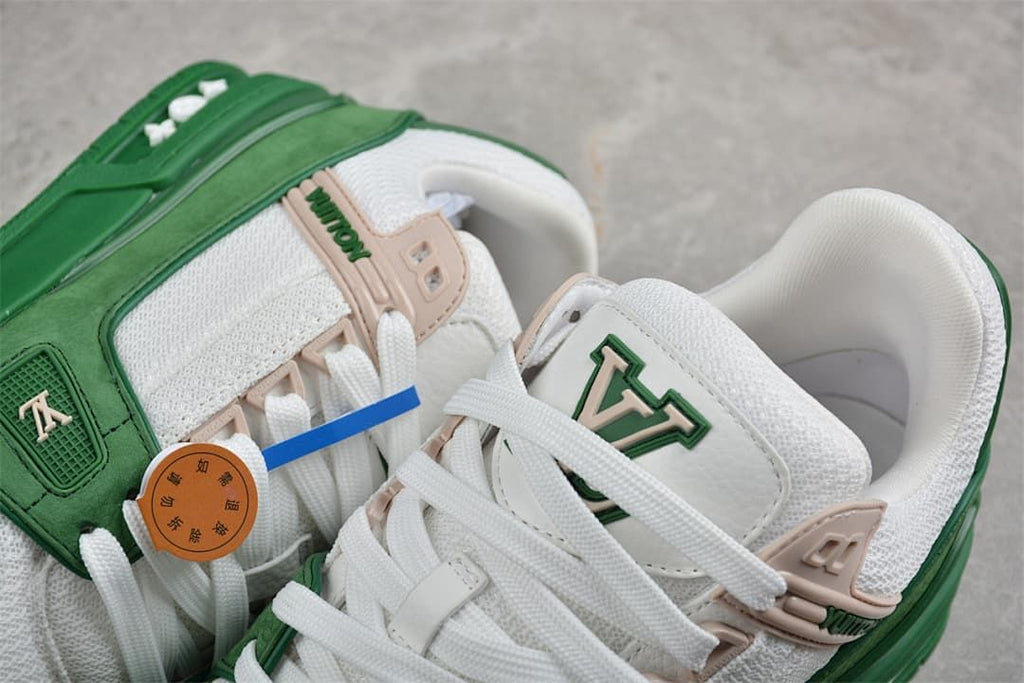 Close-up of the green and white sneakers with lace-up details and beige accents