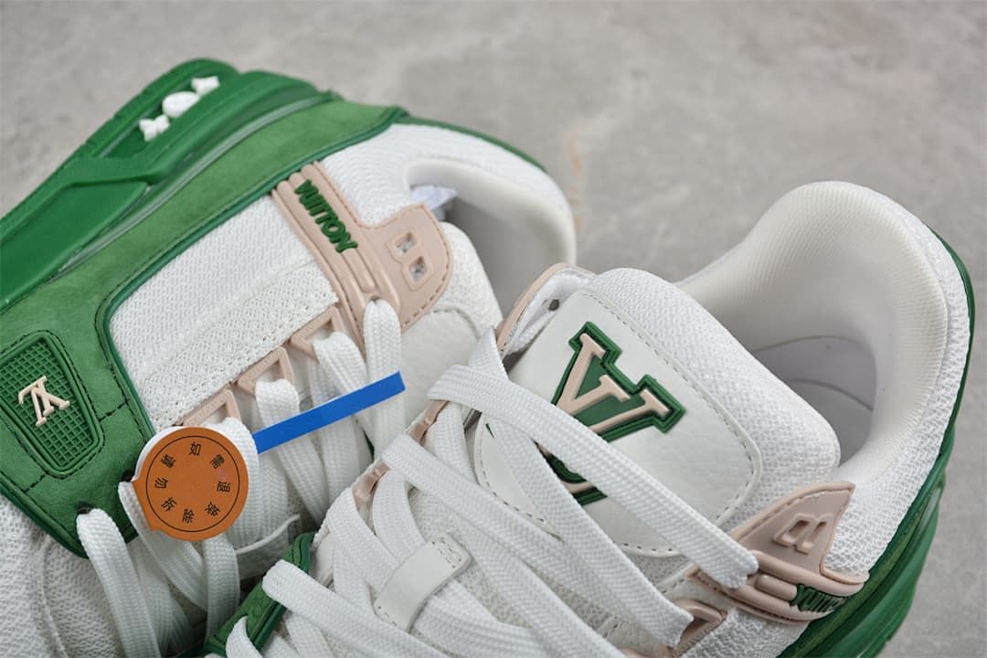 Close-up of the green and white sneakers with lace-up details and beige accents