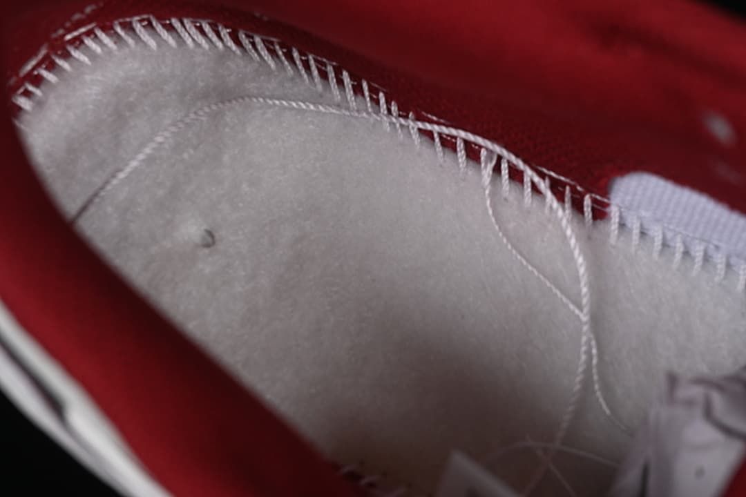 Close-up of interior stitching and burgundy lining