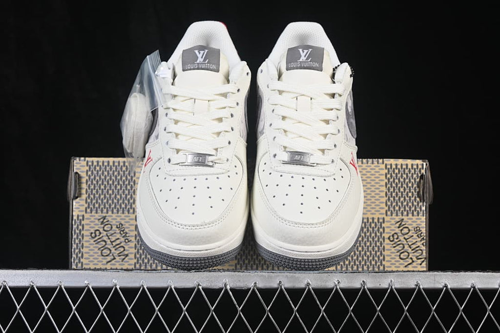 Front view of the off-white low-top sneakers with perforated toe boxes and gray detailing