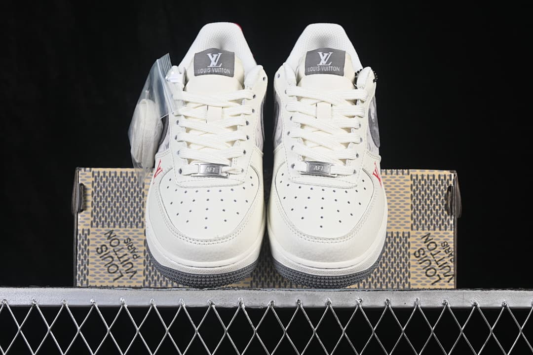 Front view of the off-white low-top sneakers with perforated toe boxes and gray detailing