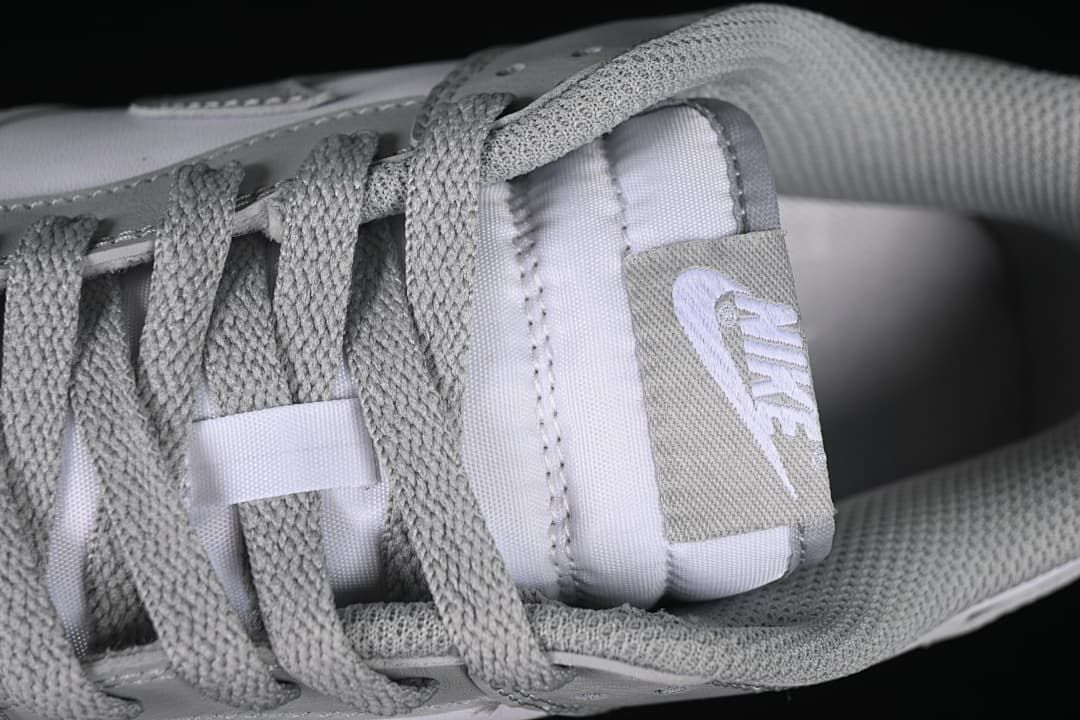 Close-up of grey laces and tongue branding
