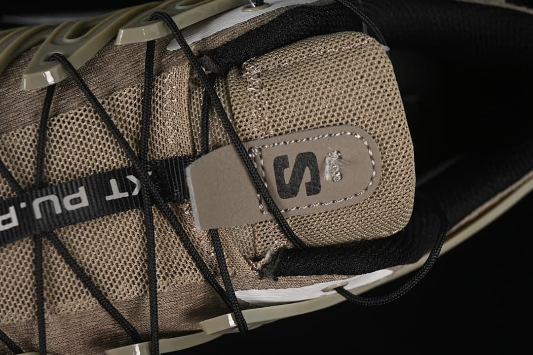 Close-up of the mesh tongue, logo patch, and black cord lacing
