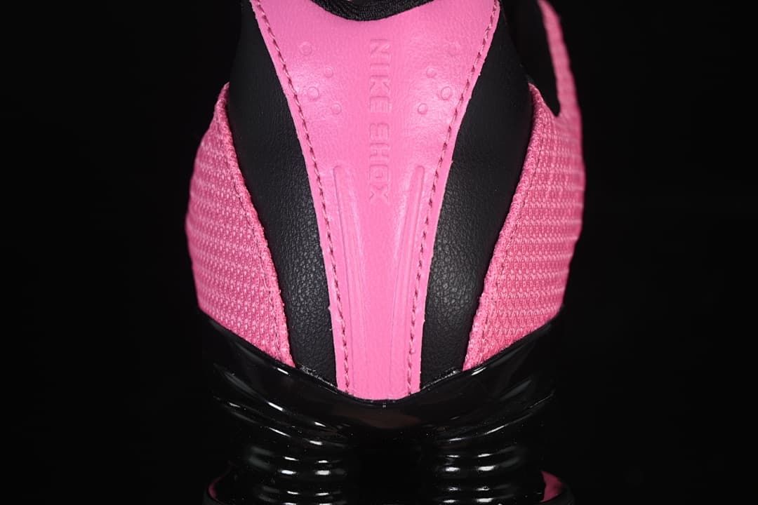Rear view showing pink heel panel, black accents, and Shox heel unit