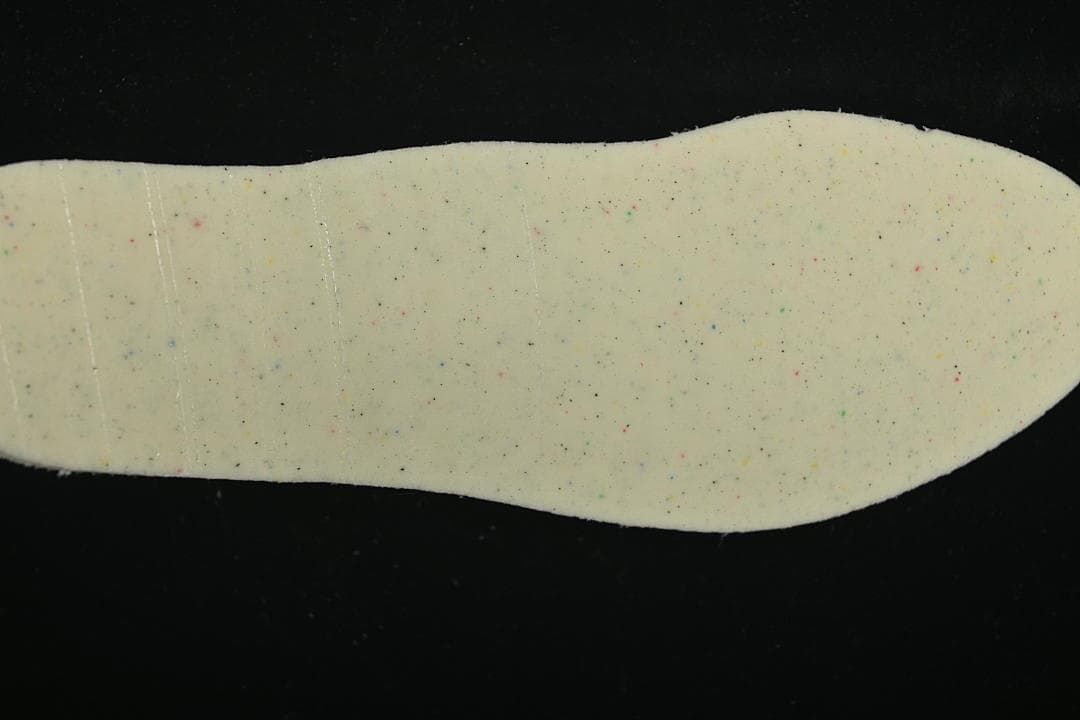 Close-up of the insole underside with small multicolor speckles.