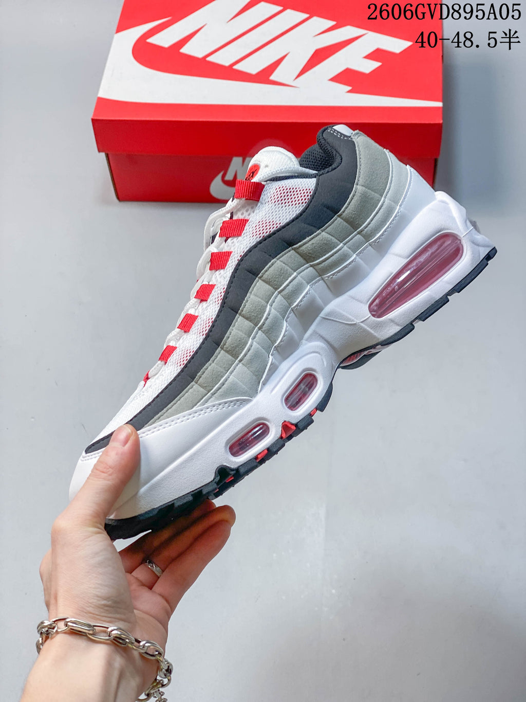 Side view of the Nike Air Max 95 with layered grey panels and visible Air cushioning.