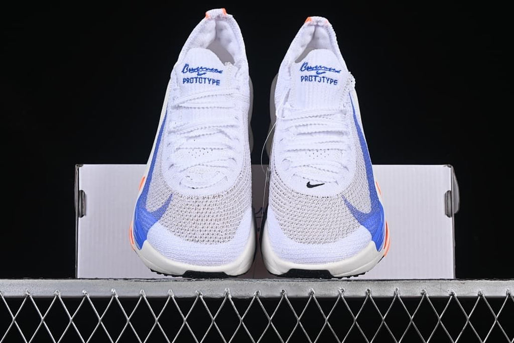 Front view of the pair of white shoes with blue and orange accents