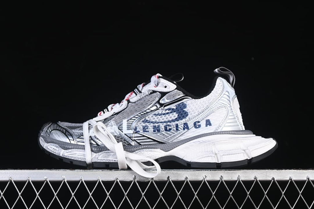 White, navy, and grey Balenciaga 3XL sneaker shown in side profile