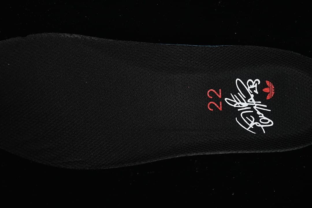 Black insole with a printed graphic and red number