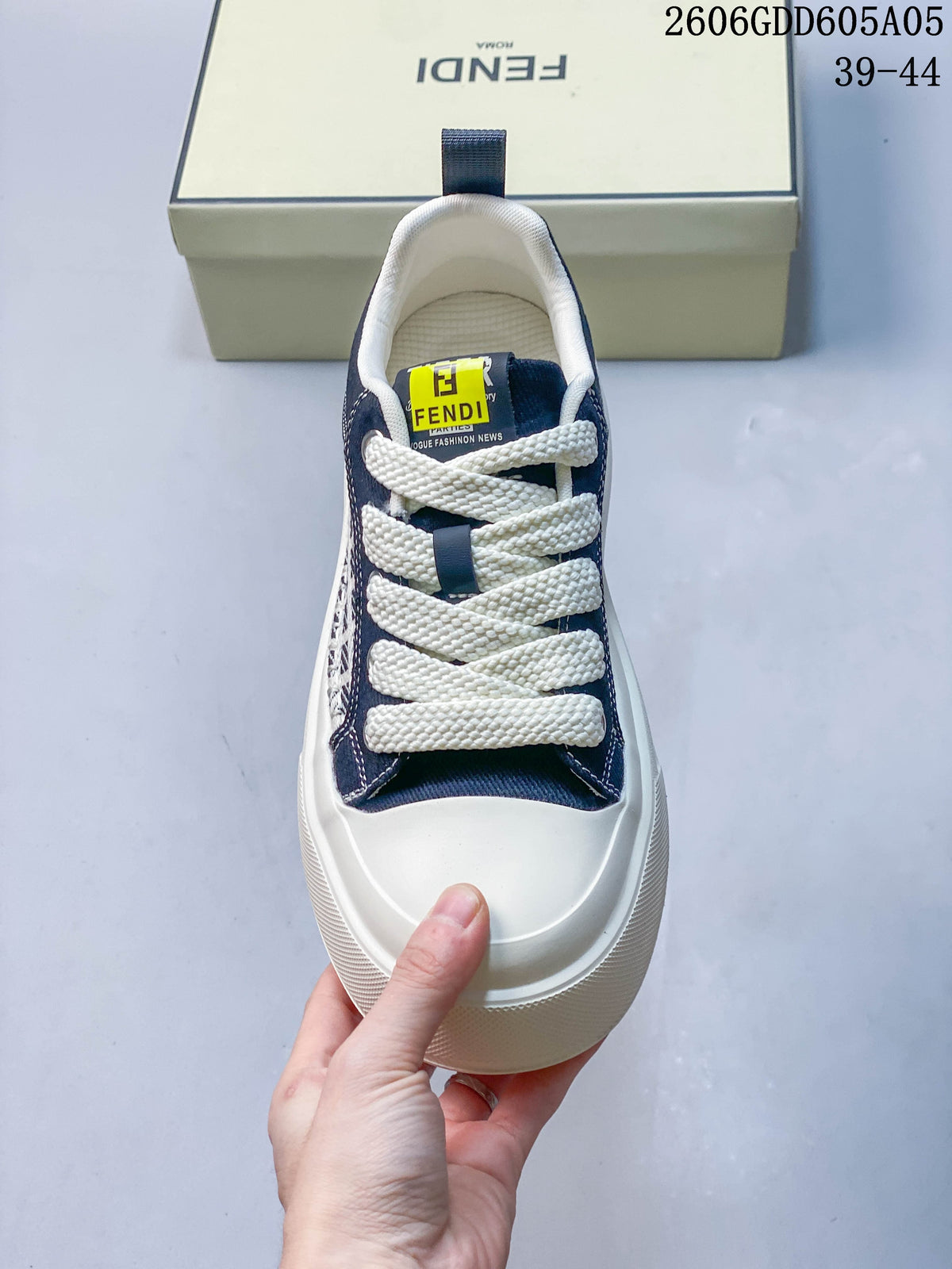 Top view of a navy and cream lace-up sneaker with a contrasting toe panel.