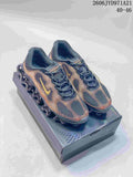 Nike Air Liquid Max shoes in a dark colorway with gold and orange accents, shown on a shoe box