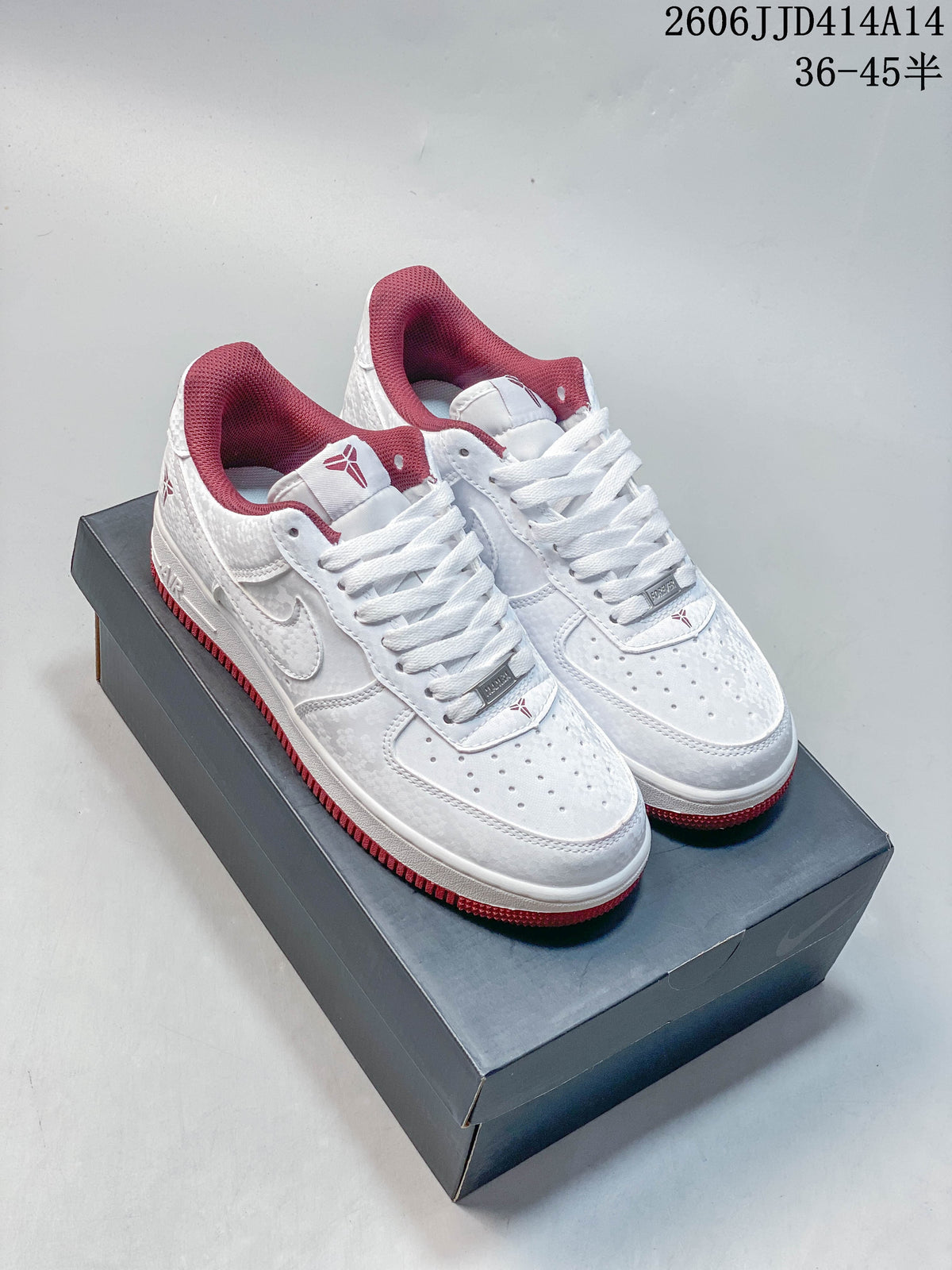 White low-top Nike Air Force 1 '07-style sneakers with red collar lining and outsole