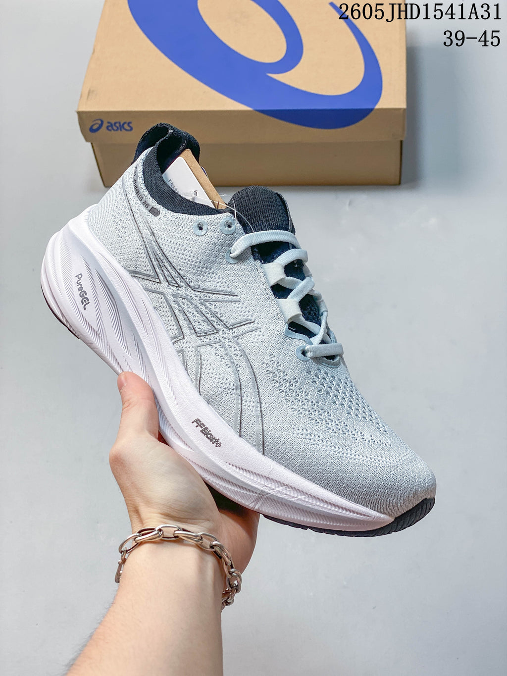 Light gray ASICS GEL-NIMBUS 26 running shoe with a dark tongue and outsole accents.
