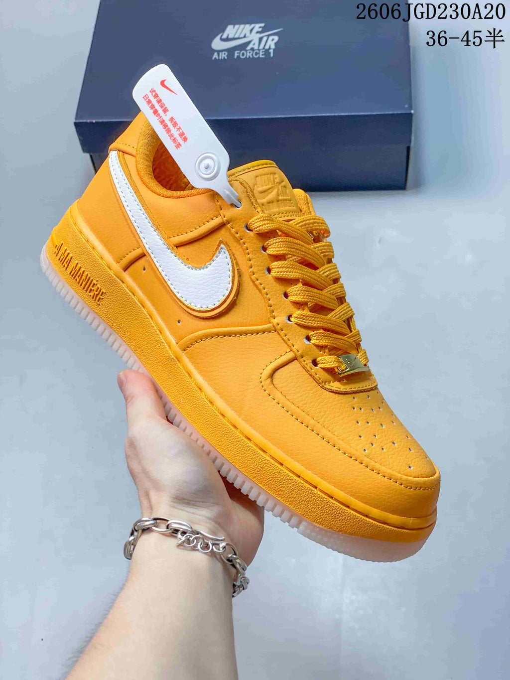 Close-up of an orange and white low-top sneaker with a white side Swoosh