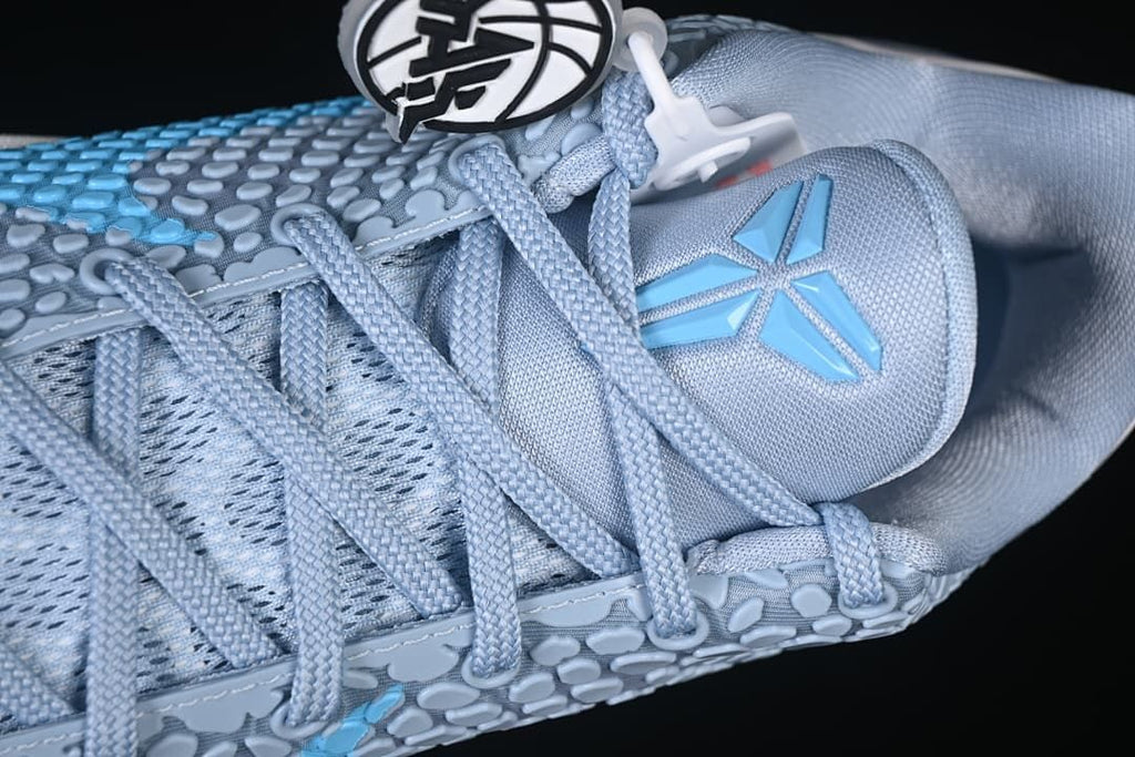 Close-up of the tongue logo and lace-up construction