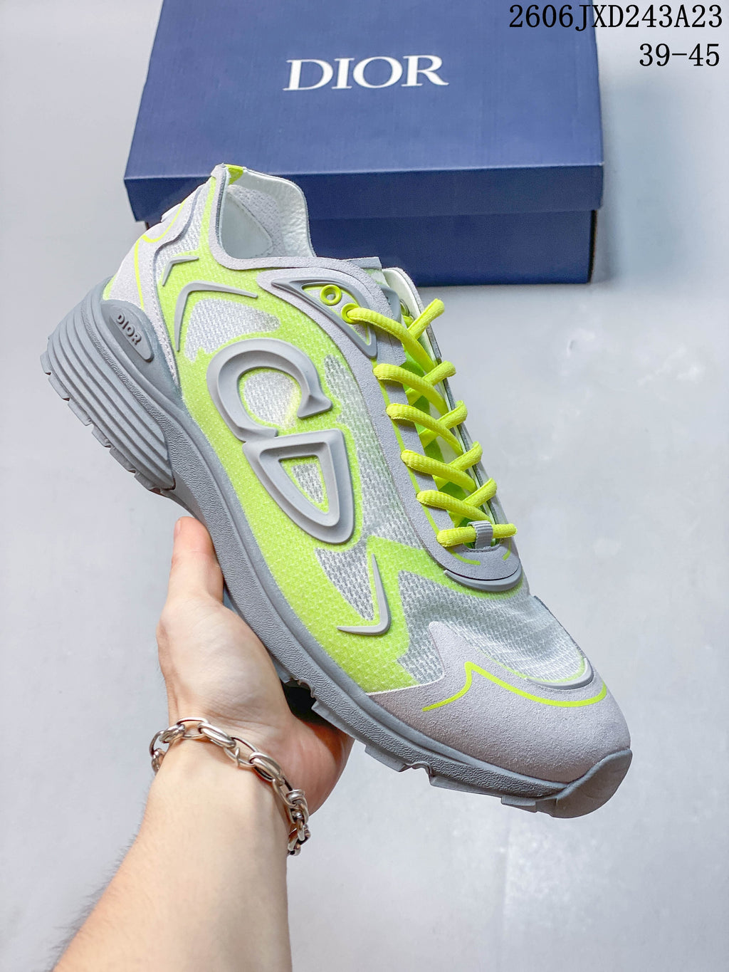 Light gray low-top sneaker with vivid lime accents and matching laces.