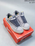 Pair of light gray Nike Devin Booker Blazer low-top sneakers with dark laces and white soles