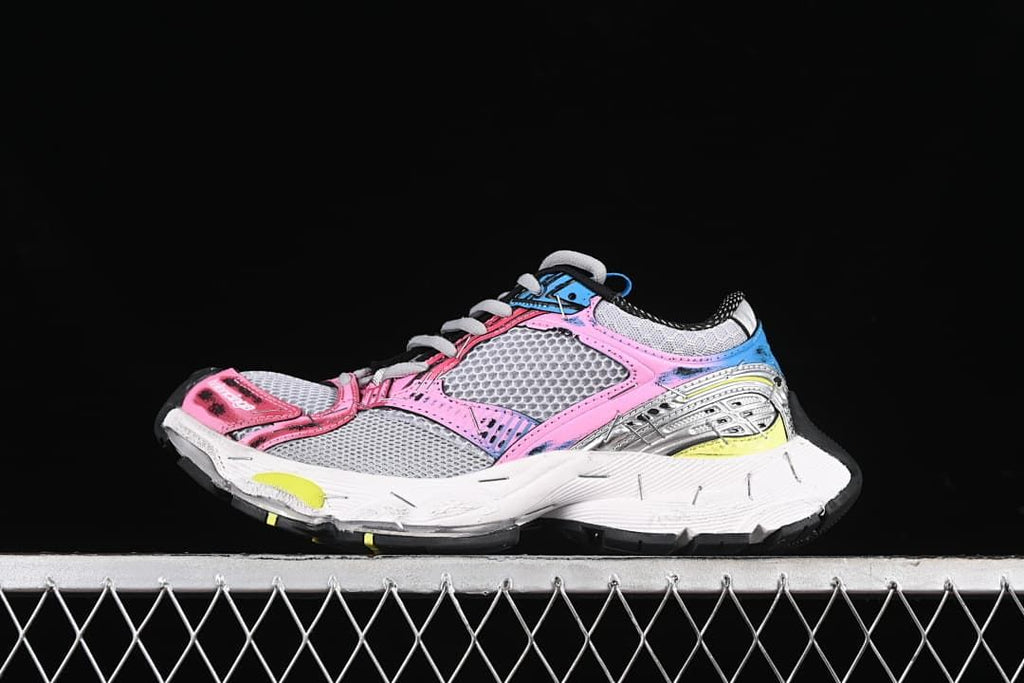 Side view of multicolor Balenciaga Stapler sneakers against a dark background