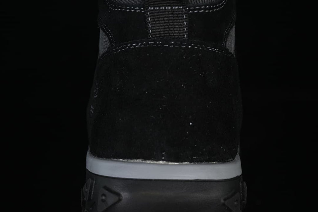 Rear view showing the boot heel, stitching, and layered sole.