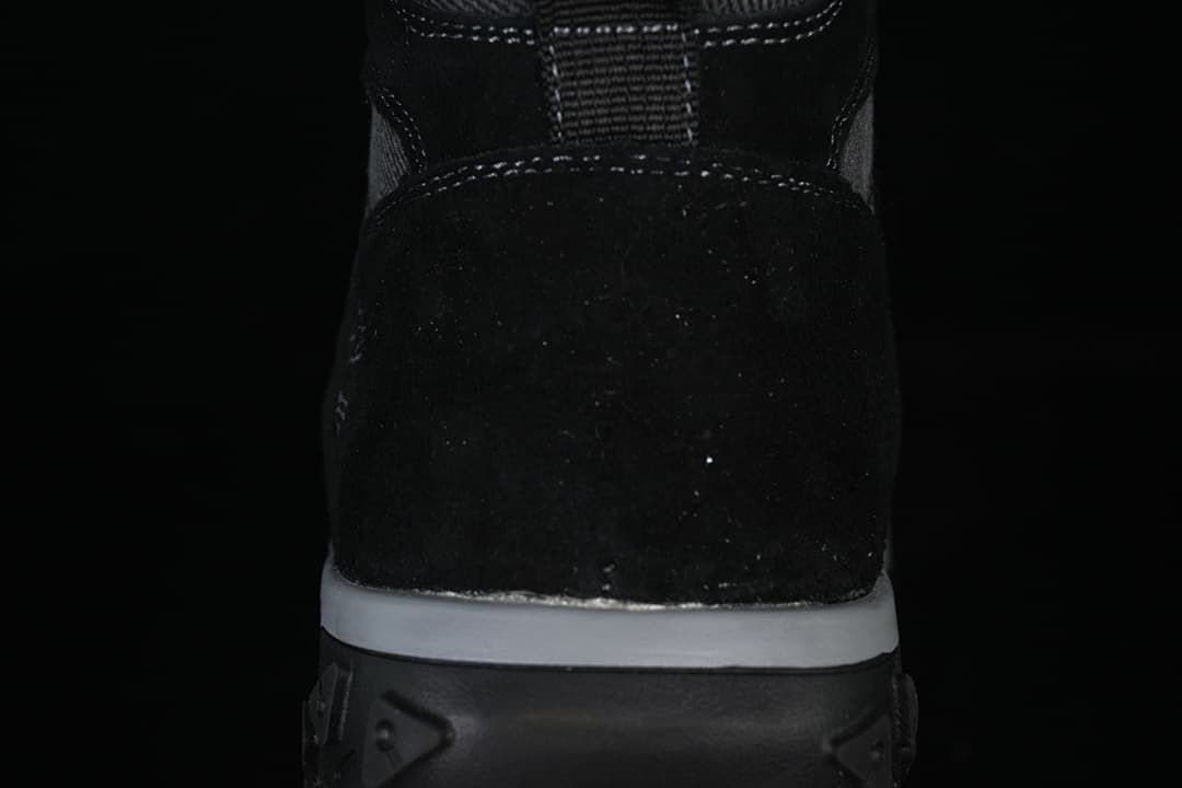 Rear view showing the boot heel, stitching, and layered sole.