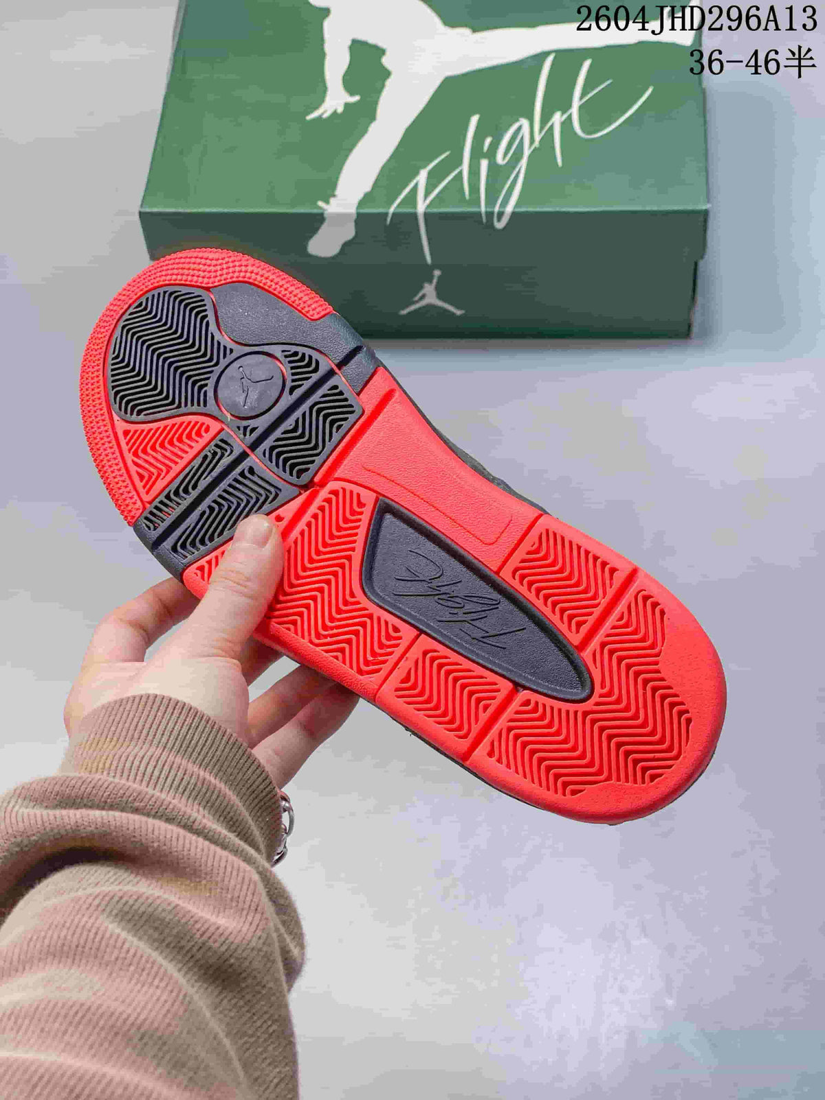 Close-up of the shoe’s red and dark gray rubber outsole with patterned tread.