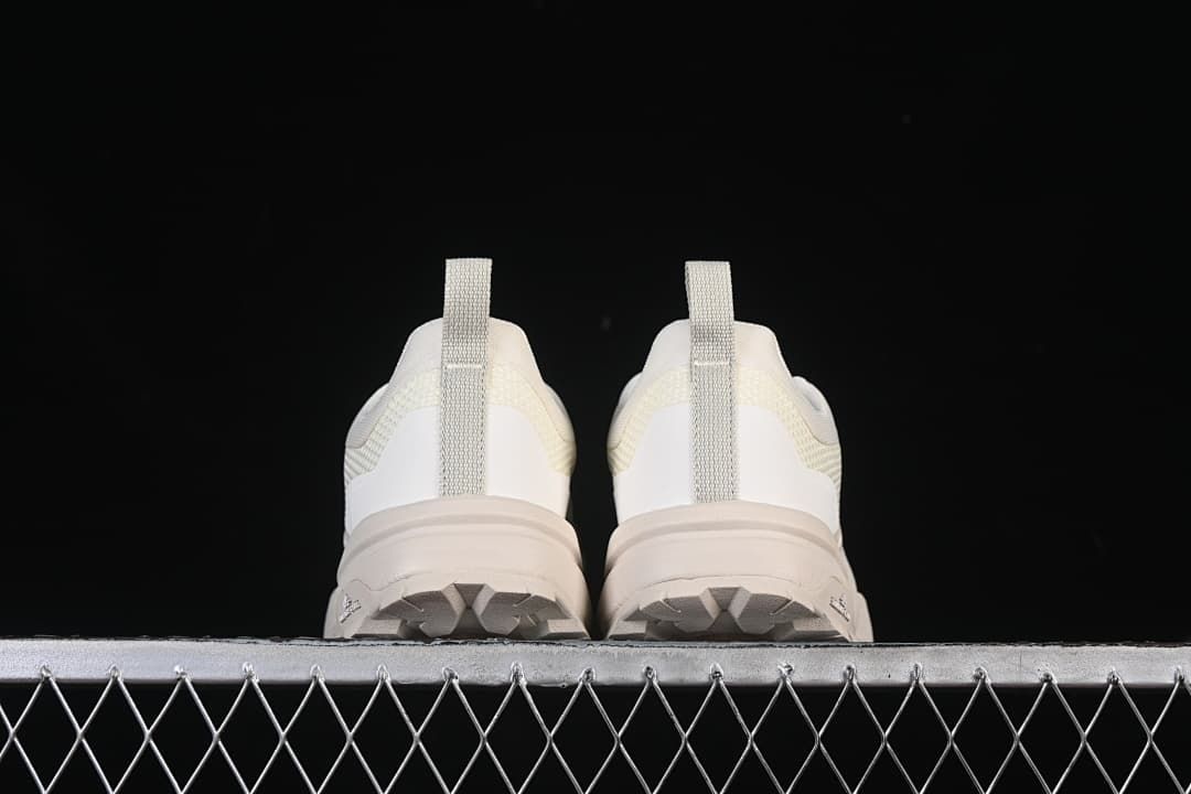 Rear view of both shoes showing heel pull tabs and outsole edges