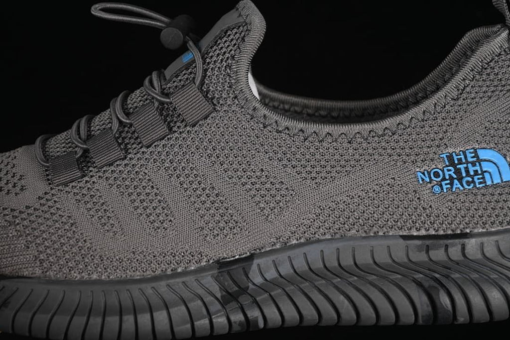 Close-up of the knit-look upper, blue side logo, toggle lacing and outsole