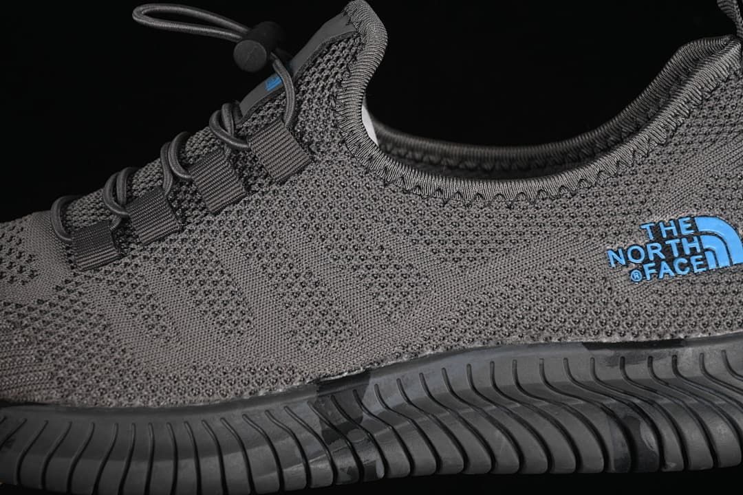 Close-up of the knit-look upper, blue side logo, toggle lacing and outsole