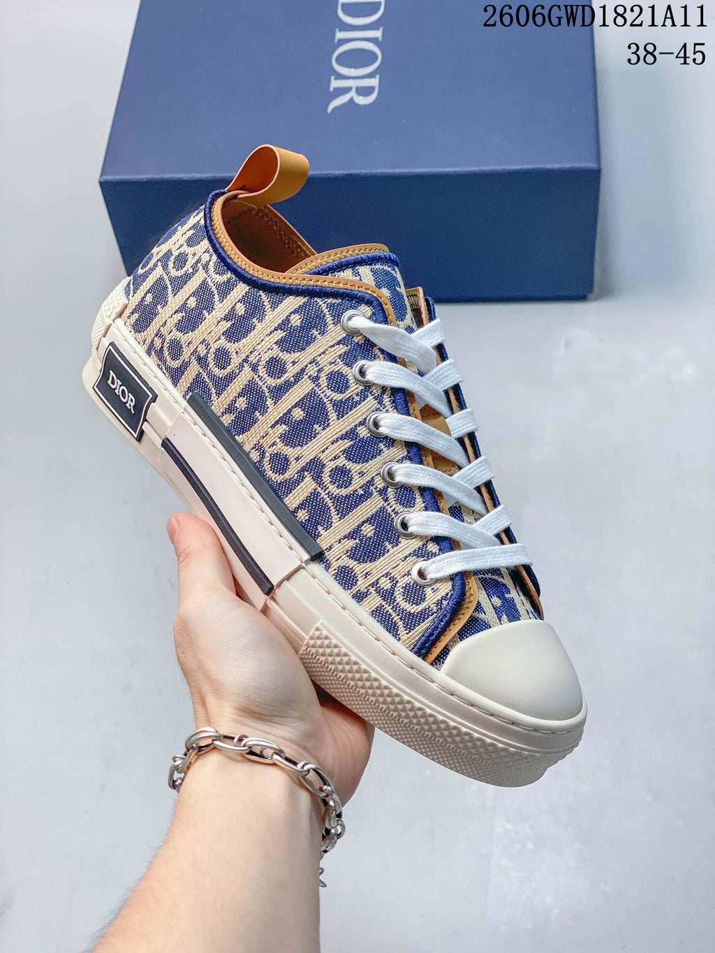 Angled side view of a patterned sneaker with a heel label, white laces, and cream-colored sole