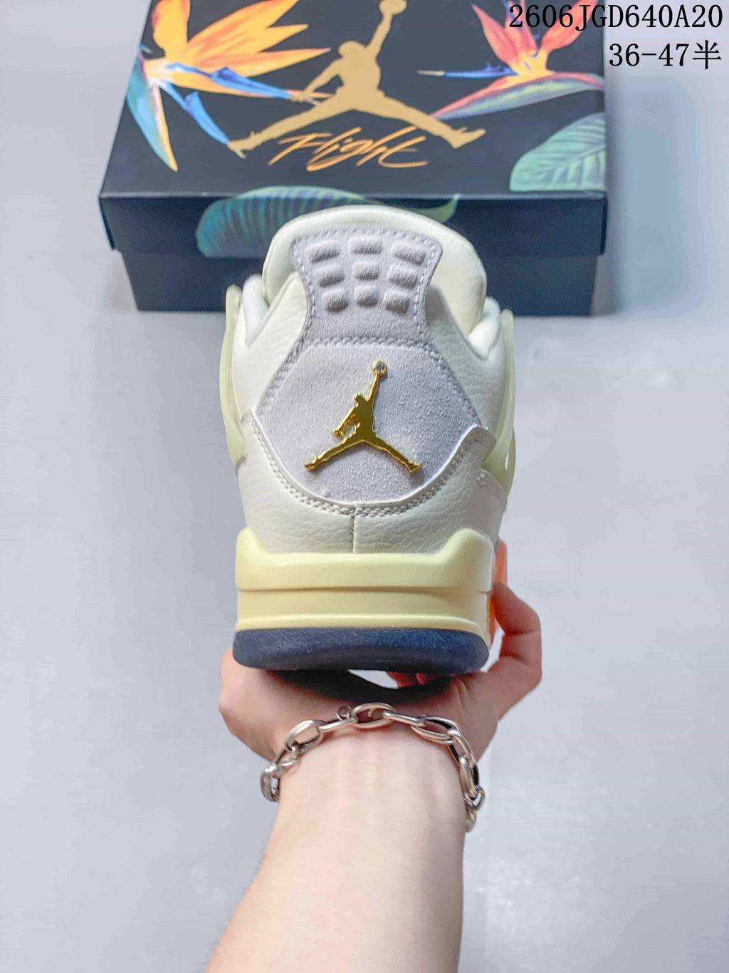 Rear view showing the heel emblem and layered sole of the Jordan Air Jordan 4 sneaker