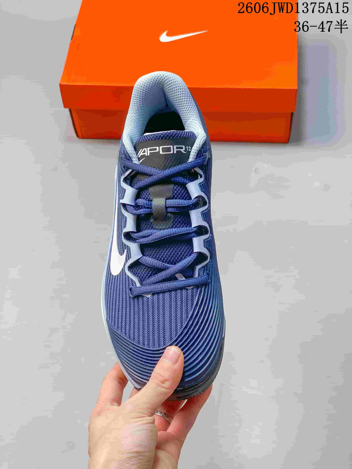 Top view of a blue Nike Vapor 12 shoe with blue laces and white accents