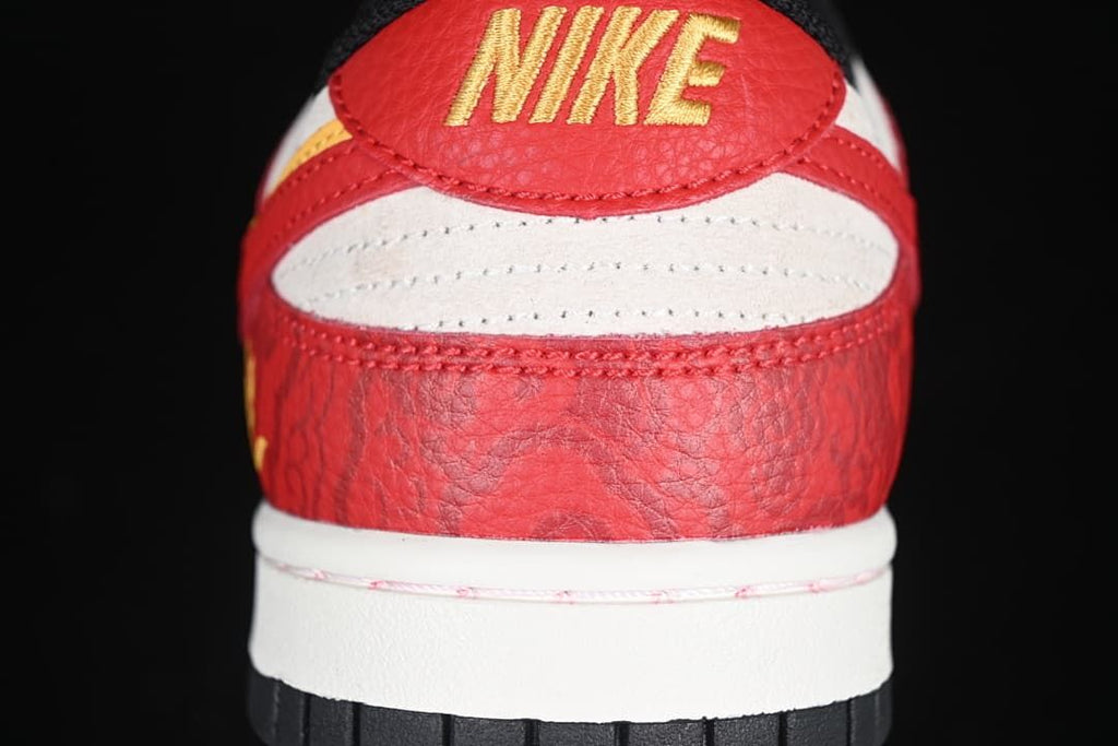 Rear close-up showing red heel panels, light-colored accents, and yellow Nike lettering