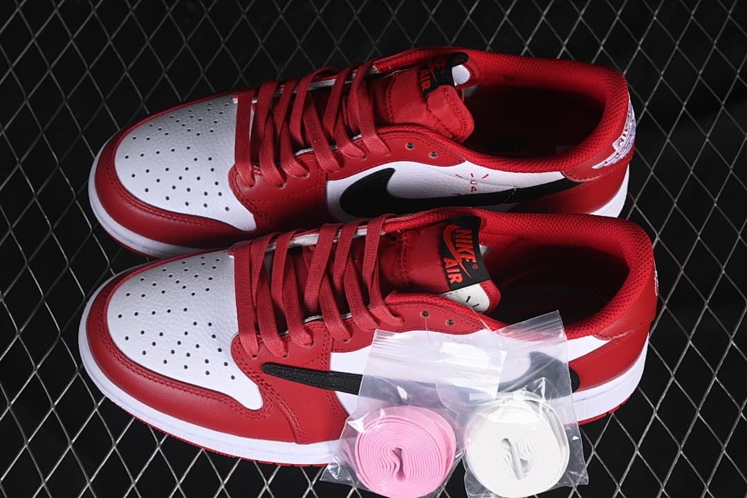 Pair of red, white, and black low-top sneakers with extra pink and white laces