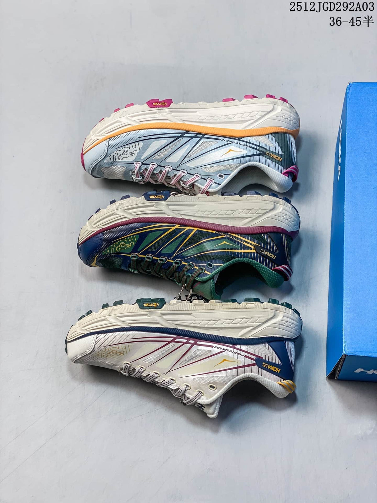 Pair of off-white HOKA Mafate Speed 2 trail shoes with burgundy and navy accents.