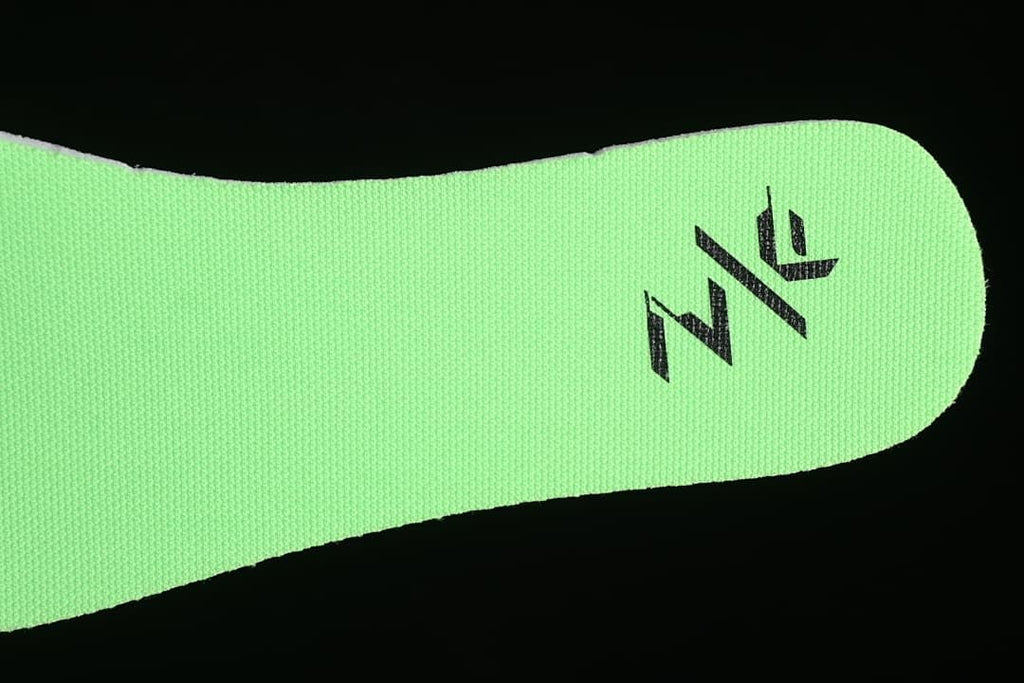 Close-up of the bright green insole with a black graphic