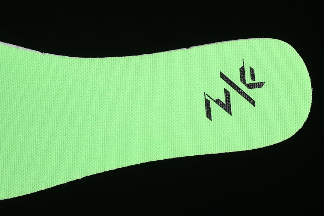 Close-up of the bright green insole with a black graphic