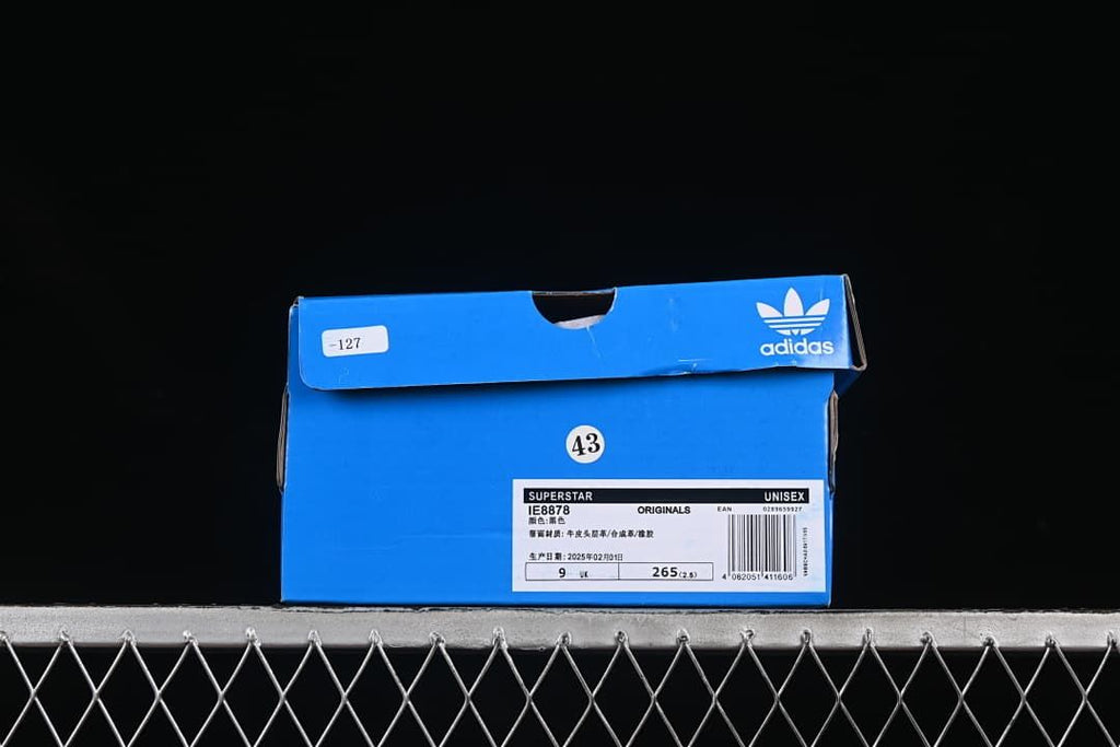 Blue adidas box labeled Superstar IE8878 with size 43 shown