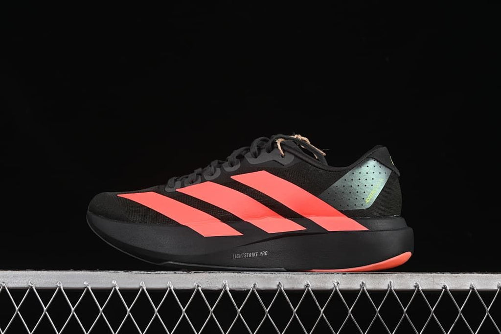Side view of a black Adidas Adizero Evo SL shoe with coral-red stripes and lime accents
