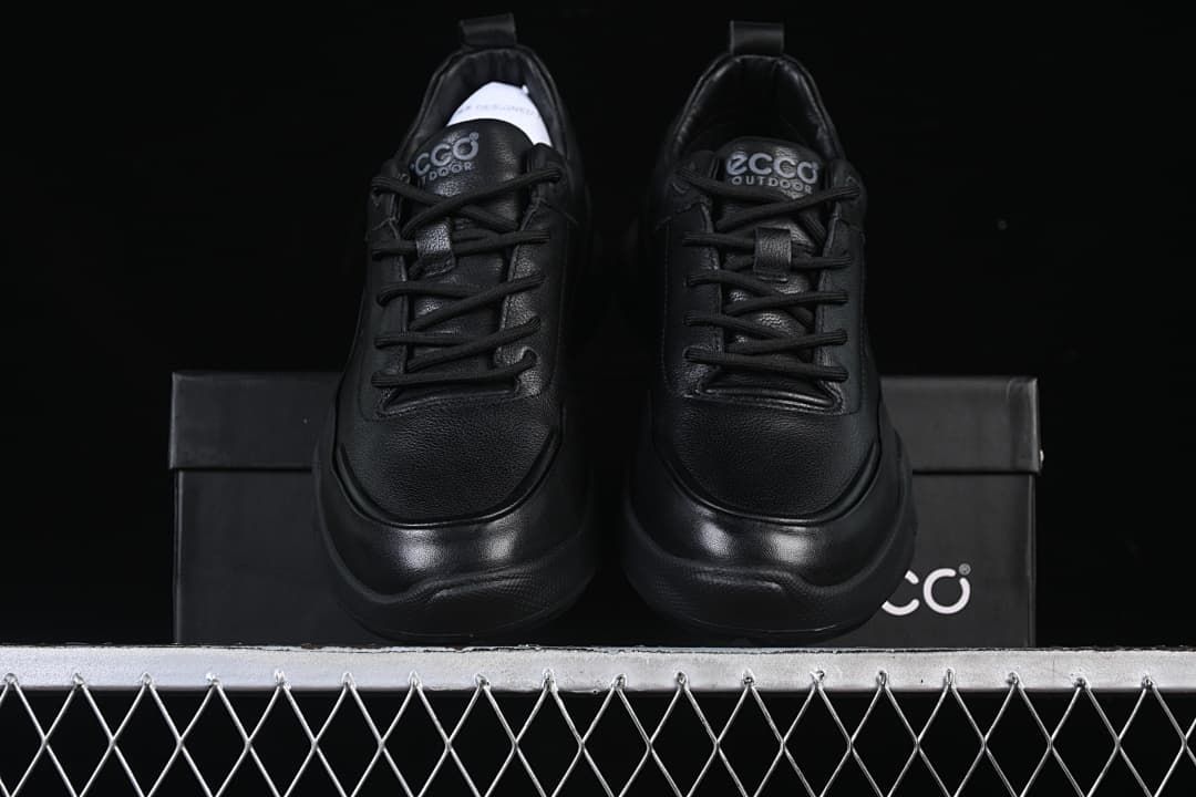 Front view of the pair of black sneakers