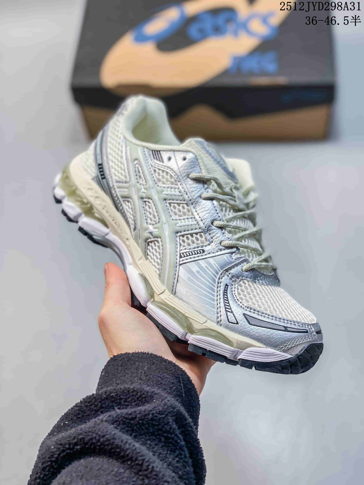 Close side view of a silver and white running sneaker with dark outsole details.