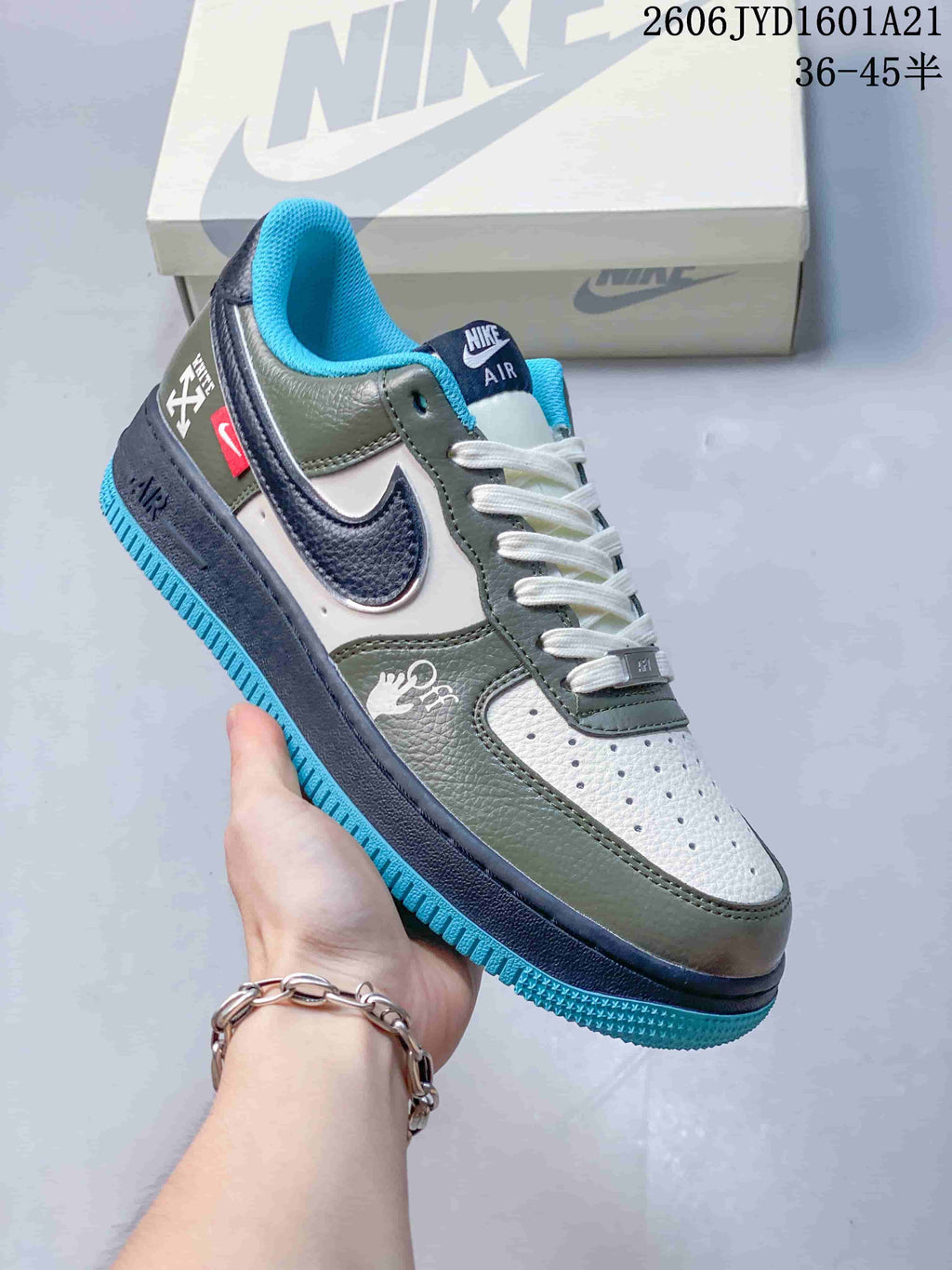 Angled side view showing contrasting panels, a navy Swoosh, and graphic details.