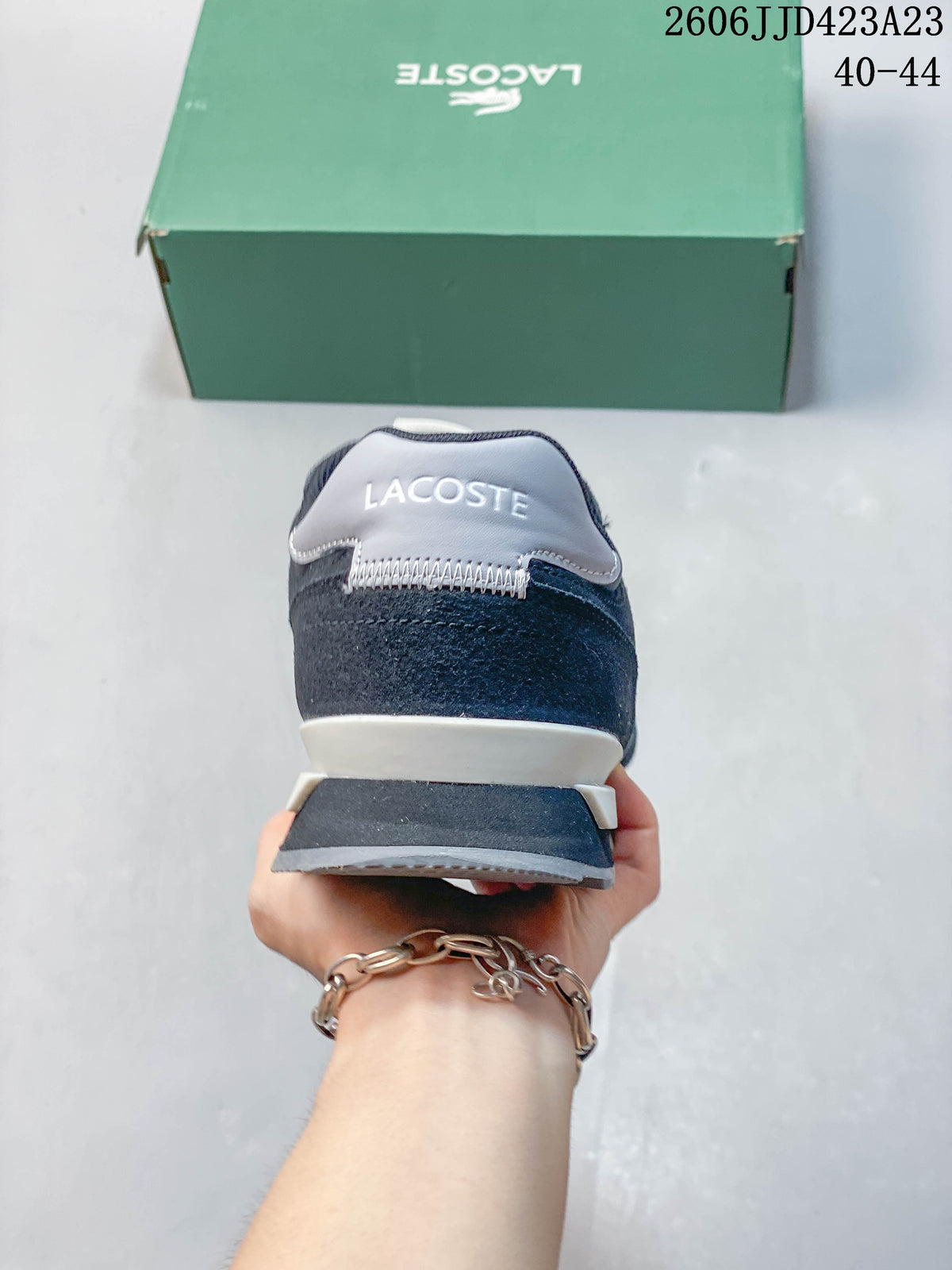 Rear view of a navy sneaker showing its light heel panel and layered sole.