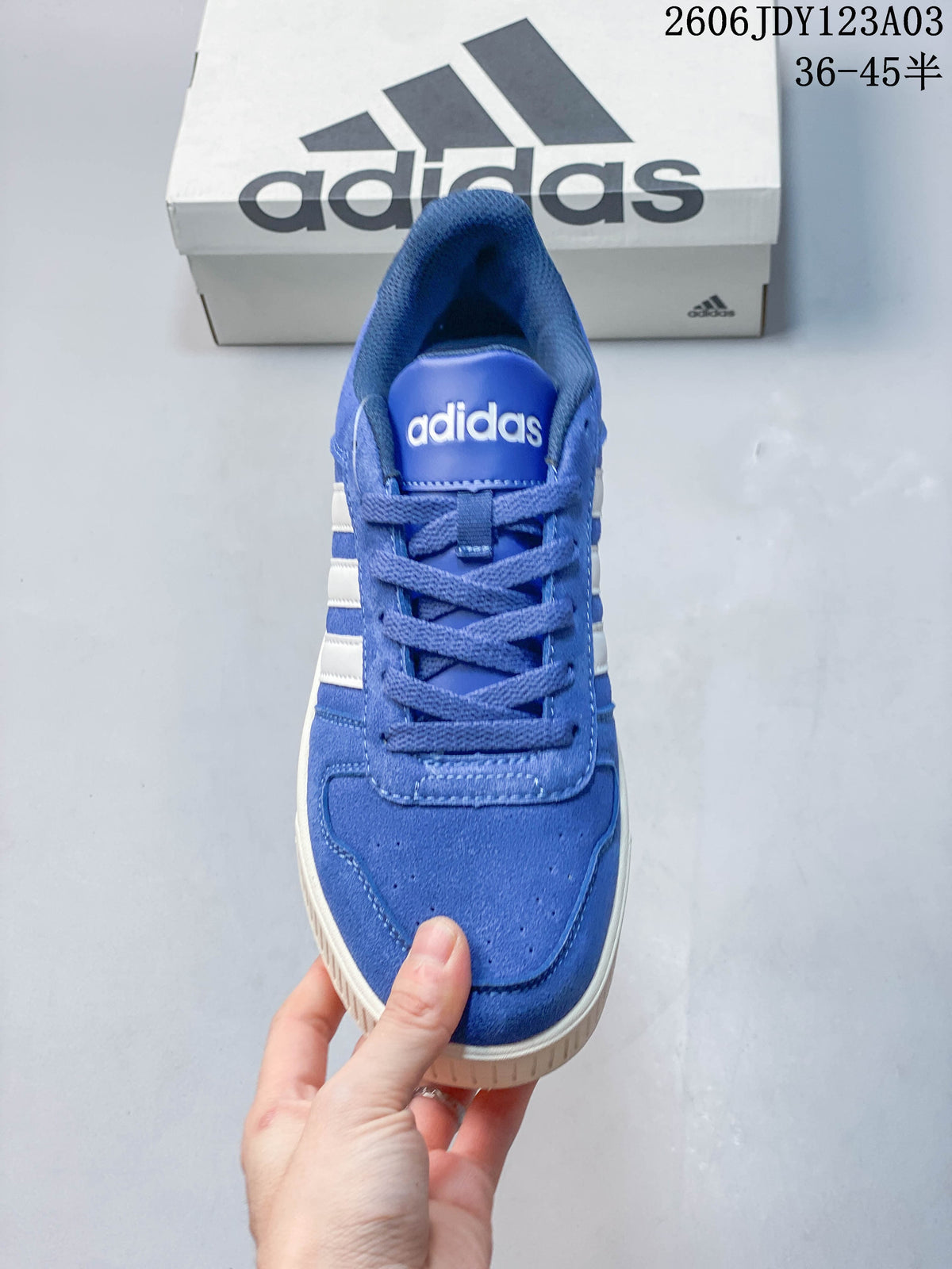 Front view of the blue lace-up sneaker with a perforated toe area