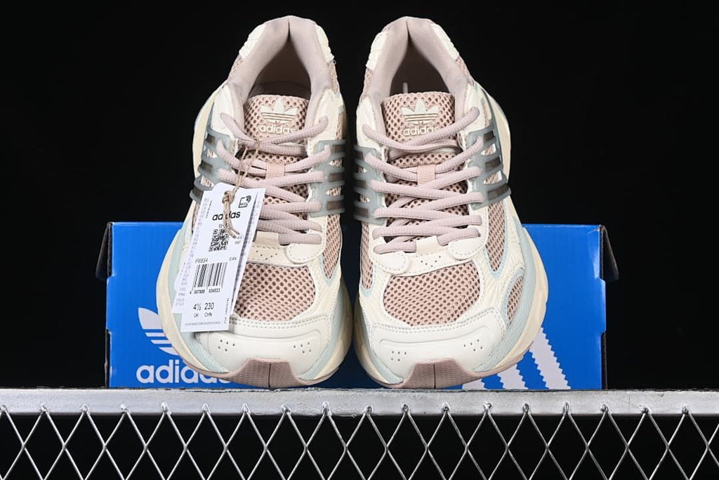 Pair of sneakers displayed on an Adidas shoe box