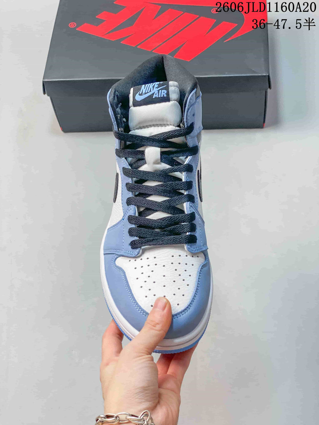 Front view showing the laces and perforated toe of a high-top sneaker